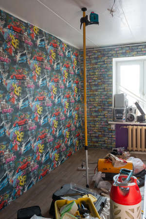 Installation of a modern seamless stretch ceiling in the apartment.のeditorial素材