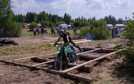 July 10, 2021. Torzhok, the village of Panika, Tver region. Motorcyclists on motorcycles overcome obstacles on the race track. Motocross. Enduro-cross. Motorcycle race with obstacles.のeditorial素材