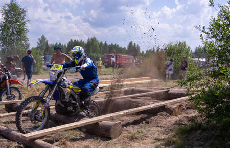 July 10, 2021. Torzhok, the village of Panika, Tver region. Motorcyclists on motorcycles overcome obstacles on the race track. Motocross. Enduro-cross. Motorcycle race with obstacles.のeditorial素材