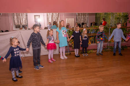 Children from large families dance at a festive event organized by a charity organization.のeditorial素材