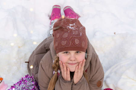 Portrait of a girl in a New Year's snowy winter forest.の写真素材