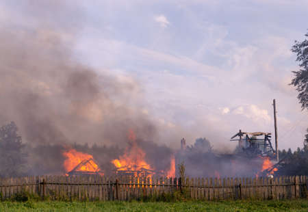 A fire in the village. Burning wooden houses in the village of Rantsevo, Tver region.の写真素材