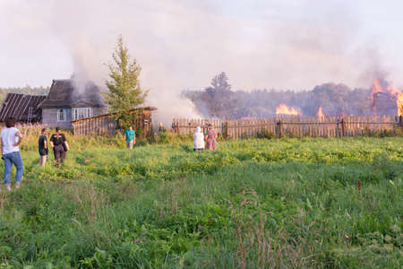 A fire in the village. Burning wooden houses in the village of Rantsevo, Tver region.のeditorial素材