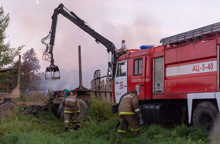 Fire service officers arrived at the scene. A fire truck at the scene of the fire. A fire in the...