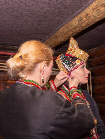 The Russian folk musical women's ensemble is preparing for a performance, trying on costumes.