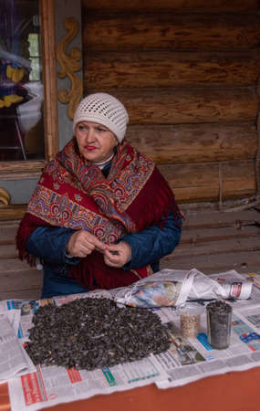 A woman sells sunflower seeds on the street.のeditorial素材
