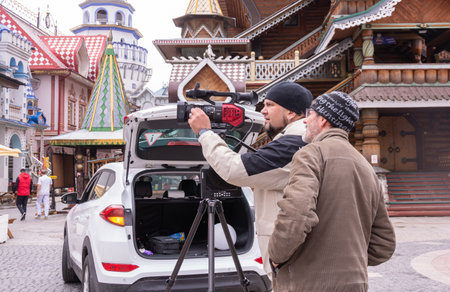 A videographer shoots a video on a video camera. The shooting process. The work of a videographer.
