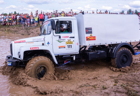The car overcomes difficult obstacles. Large-scale sports competitions of off-road cars "TVER KNEADING: RACE OF TITANS" in the "Pavlov Adventure Park" in Tver. August 12, 2022.のeditorial素材