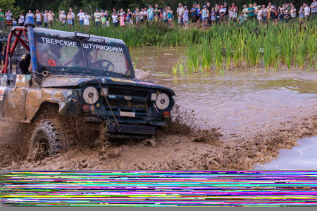 The car overcomes difficult obstacles. Large-scale sports competitions of off-road cars "TVER KNEADING: RACE OF TITANS" in the "Pavlov Adventure Park" in Tver. August 12, 2022.のeditorial素材