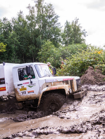 The car overcomes difficult obstacles. Large-scale sports competitions of off-road cars "TVER KNEADING: RACE OF TITANS" in the "Pavlov Adventure Park" in Tver. August 12, 2022.のeditorial素材