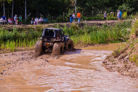 The car overcomes difficult obstacles. Large-scale sports competitions of off-road cars TVER...