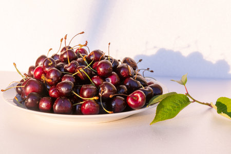 Ripe juicy large fragrant cherries on a plate.