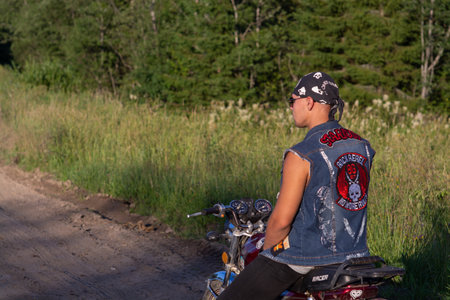 Portrait of a young man with a motorcycle on the street.の写真素材