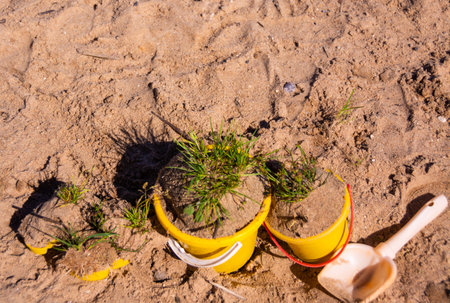 Plastic toy bucket and shovel on the sand. Selective focus.の写真素材