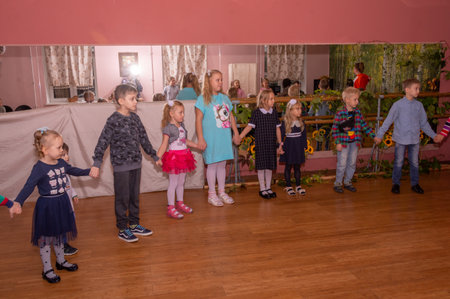 The animator plays with children from large families at a festive event organized by a charity organization.の写真素材