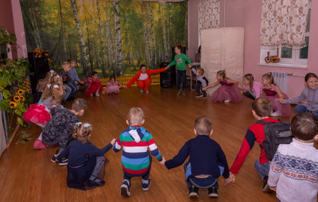 The animator plays with children from large families at a festive event organized by a charity organization.の写真素材