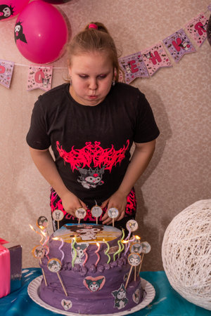 A girl with a beautiful tiered birthday cake. Birthday. Children's party.