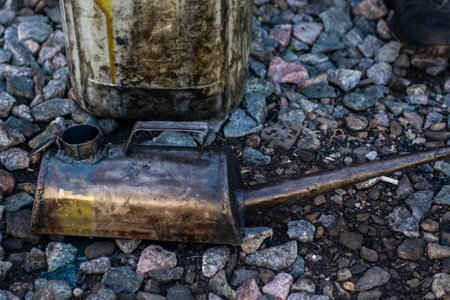A metal watering can (oil can) for pouring grease into various mechanisms and systems of the locomotive and a metal canister.の写真素材