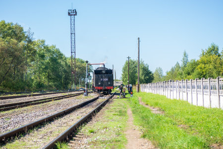 Ostashkov Tver region, Russia-08/25/2024. RETROPOEZD "SELIGER" on steam traction. The locomotive's tender is filled with water from a hydraulic columnの写真素材