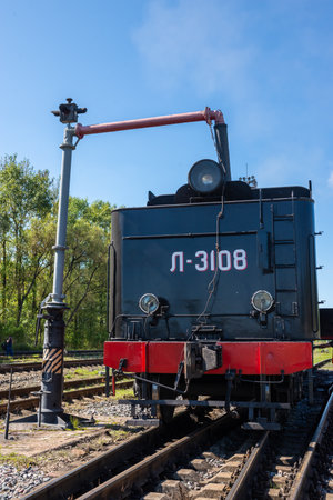 Ostashkov Tver region, Russia-08/25/2024. RETROPOEZD "SELIGER" on steam traction. The locomotive's tender is filled with water from a hydraulic columnの写真素材