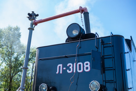 Ostashkov Tver region, Russia-08/25/2024. RETROPOEZD "SELIGER" on steam traction. The locomotive's tender is filled with water from a hydraulic columnの写真素材