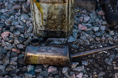 A metal watering can (oil can) for pouring grease into various mechanisms and systems of the locomotive and a metal canister.の写真素材