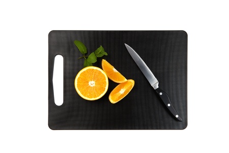 black cutting board with oranges, mintleaf and knife isolated on white backgroundの写真素材