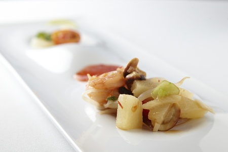 fried salad with shrimps and bamboo on white rectangular plateの写真素材