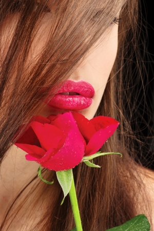 Pretty woman's lips and red roseの写真素材