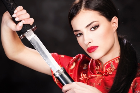Pretty woman holding katana weaponの写真素材