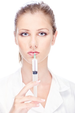 Handsome female nurse holding syringeの写真素材