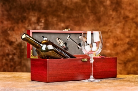 Wine cup in front of vintage wooden wine caseの写真素材