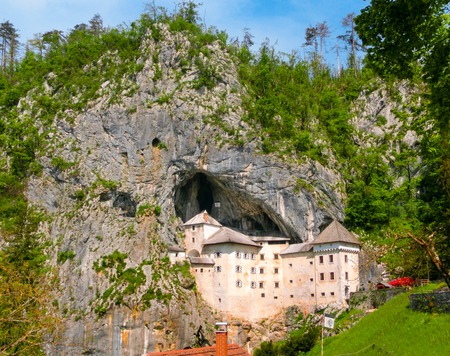 Postojna, Slovenia - May 9, 2014: View of the Predjama Castle, a renaissance castle partly built within a cave mouth and now serves as a famous tourist destination in Postojna, Slovenia.のeditorial素材