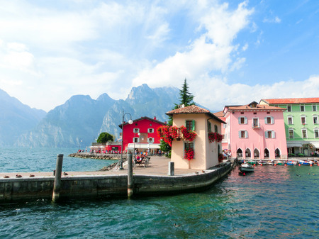 Torbole, Italy - September 21, 2014: Lake Garda boardwalk with houses, tourists and boats in Torbole, Italy. Torbole is one of the most popular towns on Garda Lake, known as a wind surfers paradise.のeditorial素材