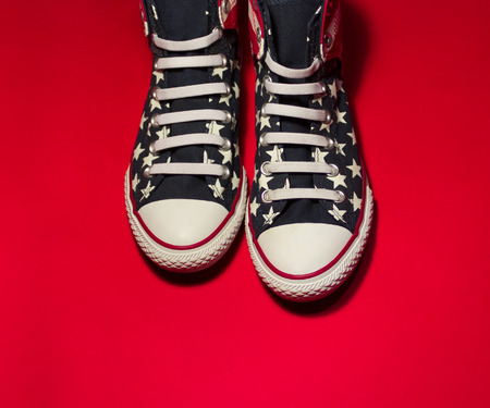 Dnipropetrovsk, Ukraine - May, 29 2016: All Star Converse sneakers on red backgroundのeditorial素材