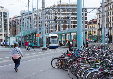Geneva, Switzerland - June 17, 2016: The city tram and bicycles on street in Genevaのeditorial素材