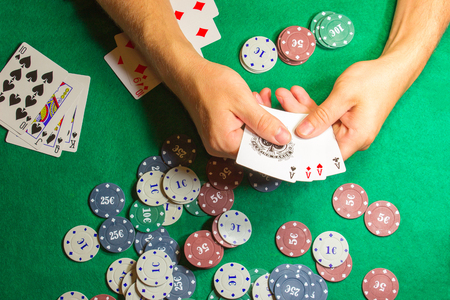 The male hands with cards in casino and chipsの写真素材