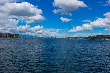 Lake Geneva. Panoramic view of harbor district with blue sky and clouds in summer, Canton of Geneva, Switzerlandの写真素材