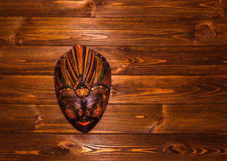 Traditional Indonesian mask, Baliness, on wooden backgroundの写真素材