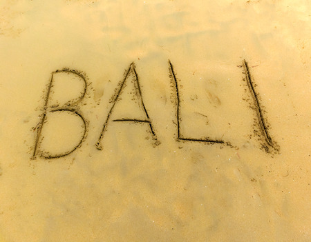 The inscription on and from the sand Bali .の写真素材