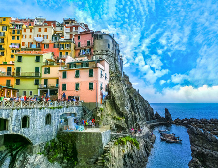 Colorful traditional houses on a rock over Mediterranean seaの写真素材