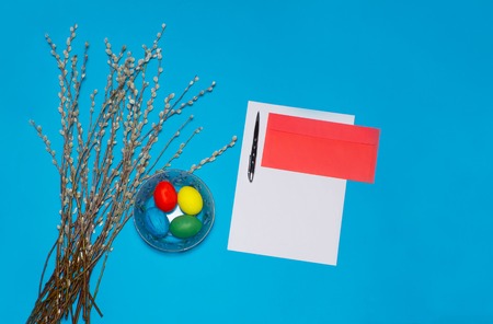 Easter eggs and blooming willow on blue