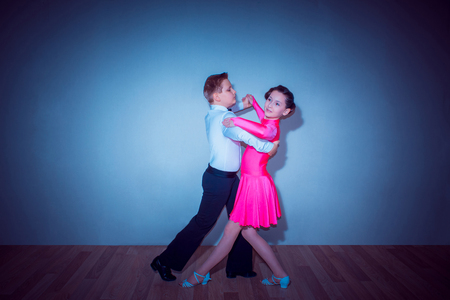The young boy and girl posing at dance studioの写真素材