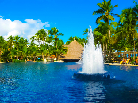 Punta Cana, Dominican republic - February 04, 2013: Ordinary tourists resting in Barcelo Bavaro Beach hotel with pool under palmsのeditorial素材
