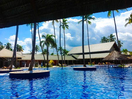 Punta Cana, Dominican republic - February 04, 2013: Ordinary tourists resting in Barcelo Bavaro Beach hotel with pool under palmsのeditorial素材