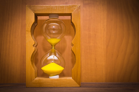 Hourglass as time passing concept for business deadline, urgency and running out of time.の写真素材