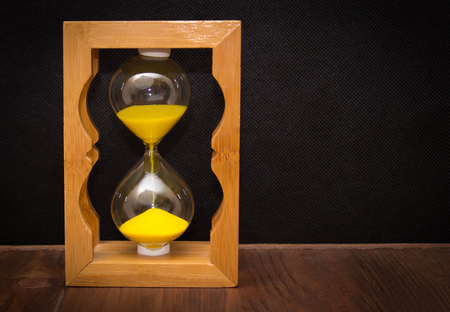 Hourglass as time passing concept for business deadline, urgency and running out of time.