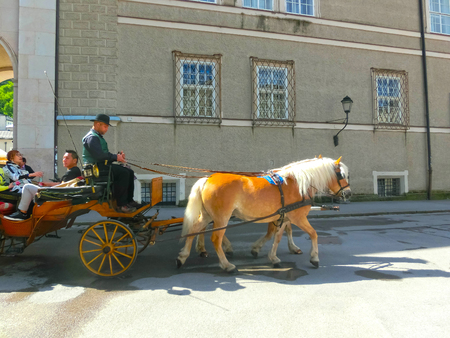 Salzburg, Austria - May 01, 2017: Central place in Salzburg city with carriages and horsesのeditorial素材