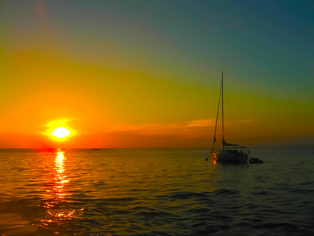 Small boats at the Andaman Sea in sunset