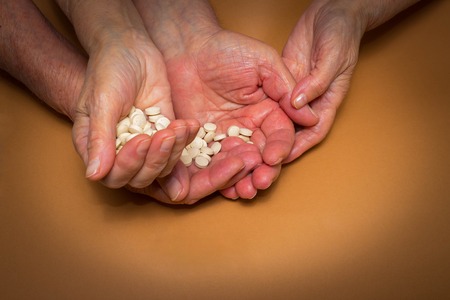 The old hands with pillsの写真素材